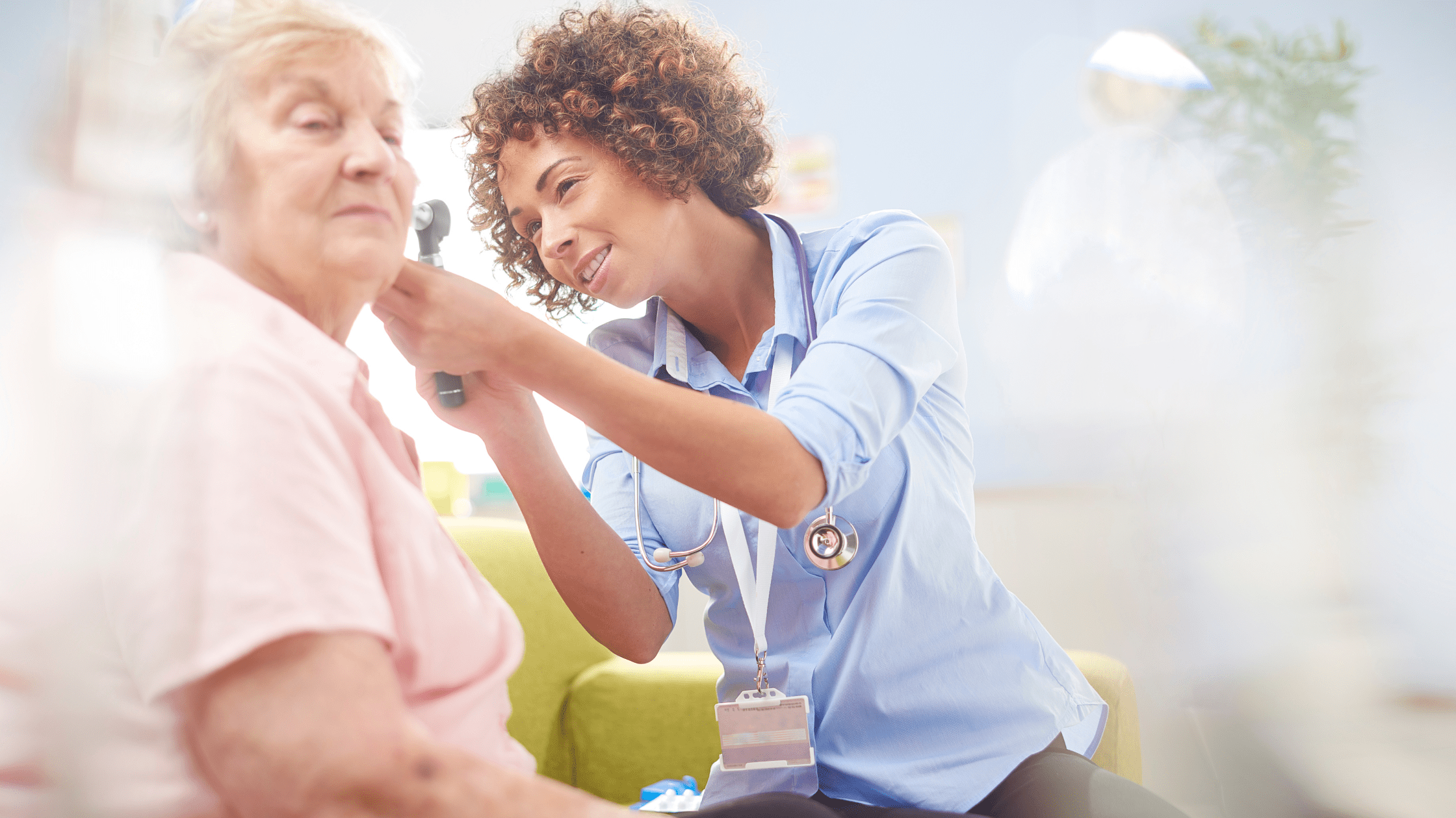 An ENT resident using an otoscope to examine her patient.